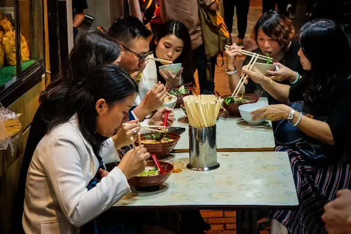 People Around A Table In South Korea Felix Lannoo
